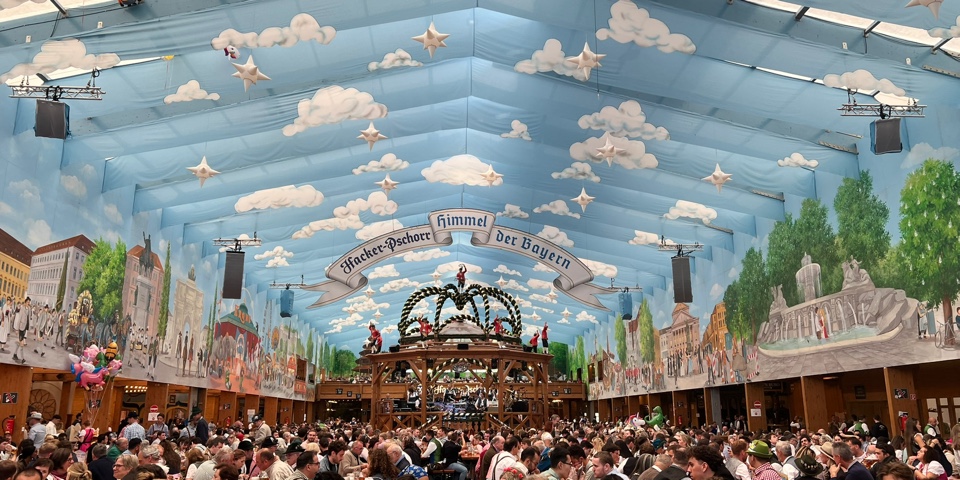 Straight-on view of the blue sky ceiling inside the Hacker-Pschorr Oktoberfest tent in Munich
